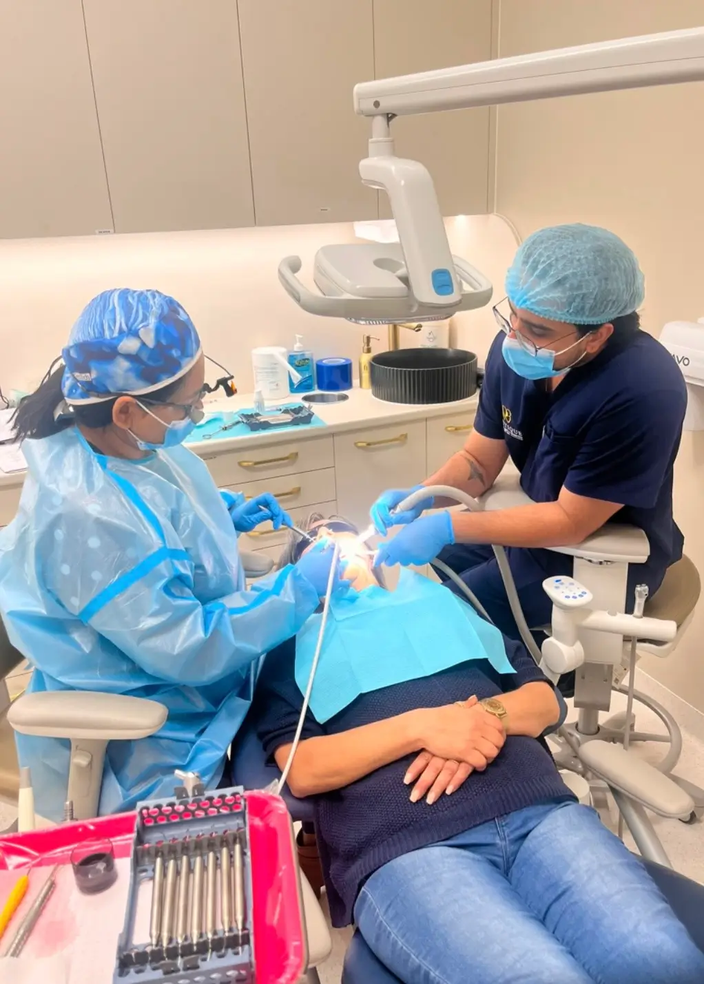 Dental team providing treatment to a patient in the clinic